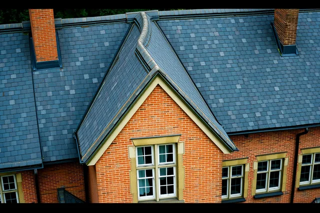 Roof seams and joints on a large historic mansion reveal later building campaigns. Mansions architecture: reading building campaigns through roof seams